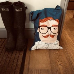 Blue cotton tote bag with Luke a red haired chap with black glasses and moustache