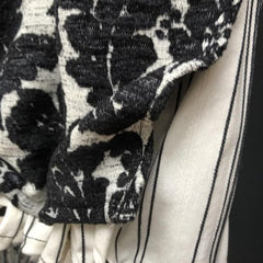Close up view of Lydia Lady Lamp floral black & white over coat and under coat of natural line with thin black stripe.