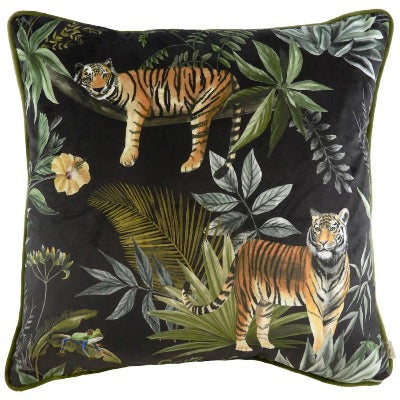 Jungle Tiger Velvet Cushion Black backdrop, two lines one relaxing the other pacing set in a tropical leave backdrop